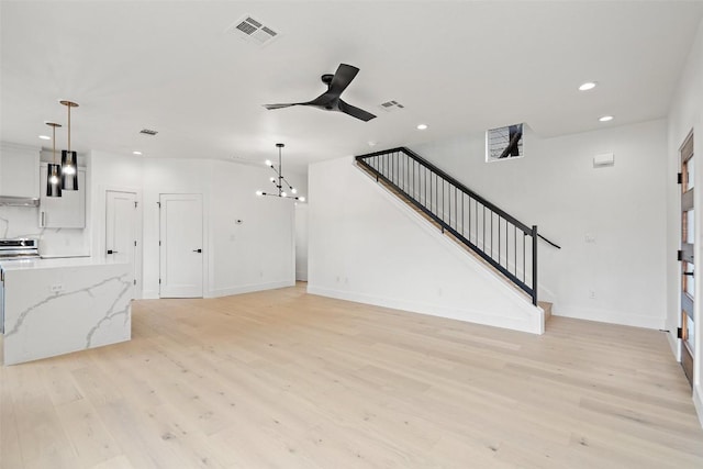 1212 Poquito St Unit 2, Austin, TX 78702 - unfurnished living room featuring a ceiling fan, light wood finished floors, recessed lighting, and stairway