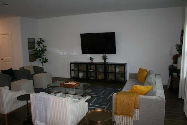 living room with dark wood-style floors and visible vents