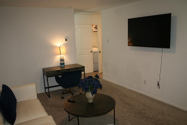 living room featuring washer / dryer and dark colored carpet