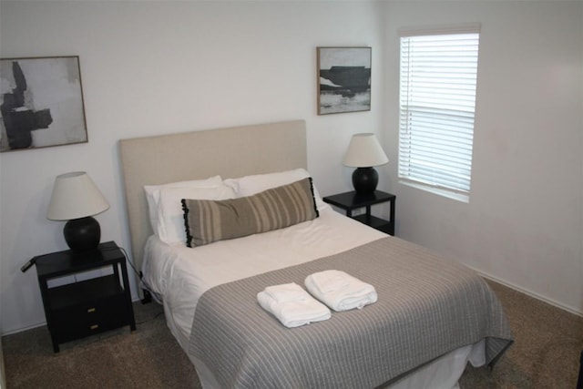 bedroom featuring dark colored carpet