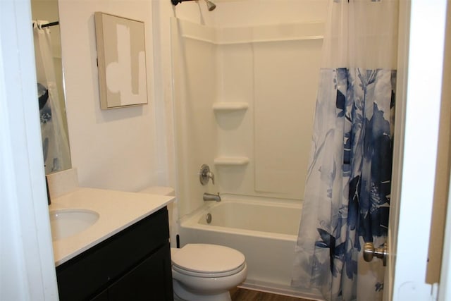 bathroom featuring vanity, shower / bath combo with shower curtain, and toilet