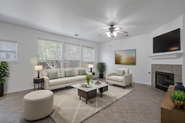 6205 York Bridge Cir, Austin, TX 78749 - tiled living area featuring ceiling fan, a fireplace, and baseboards