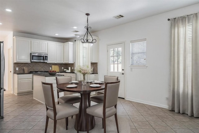 6205 York Bridge Cir, Austin, TX 78749 - dining space featuring light tile patterned flooring, recessed lighting, and baseboards