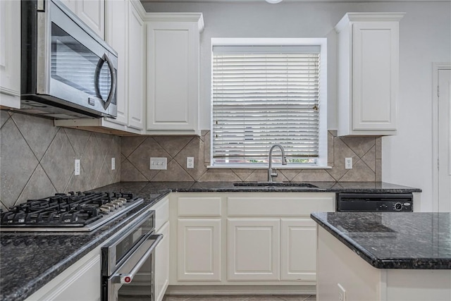 6205 York Bridge Cir, Austin, TX 78749 - kitchen featuring stainless steel appliances, a sink, white cabinetry, and dark stone countertops