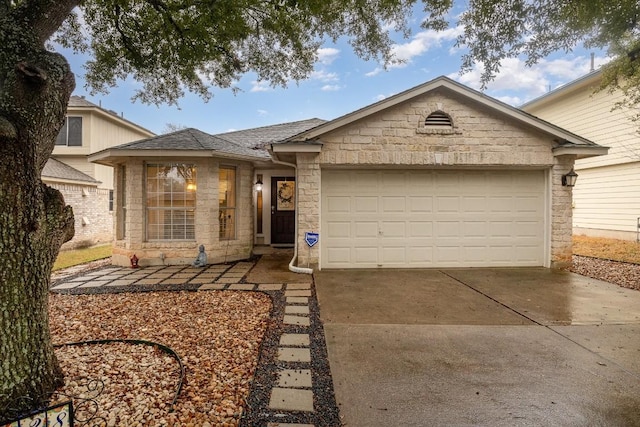 single story home featuring an attached garage, stone siding, a shingled roof, and concrete driveway