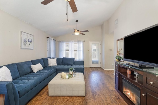 living room with lofted ceiling, a ceiling fan, baseboards, and dark wood-style flooring