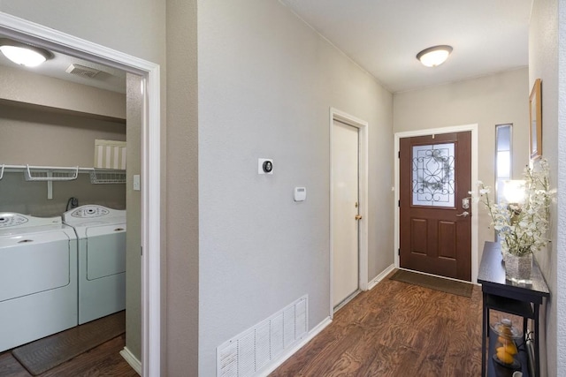 entryway with baseboards, visible vents, dark wood-style flooring, and independent washer and dryer