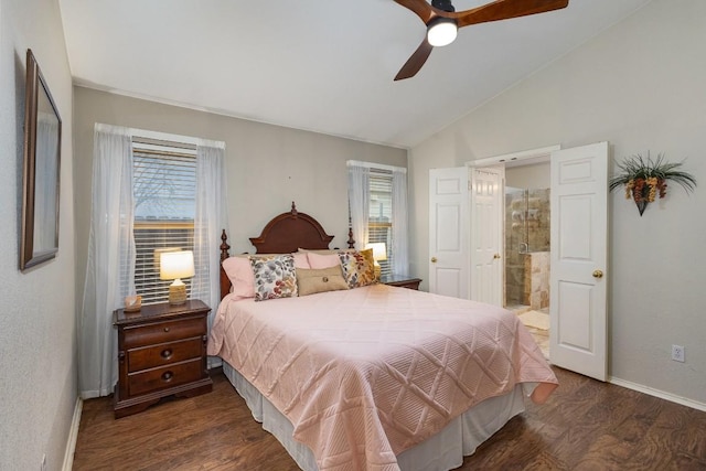 bedroom featuring baseboards, lofted ceiling, dark wood-style floors, ensuite bath, and ceiling fan