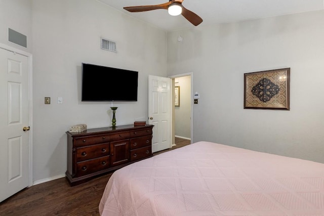 bedroom featuring dark wood-style flooring, a ceiling fan, visible vents, vaulted ceiling, and baseboards