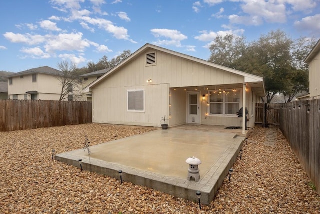 back of property featuring a patio area and a fenced backyard