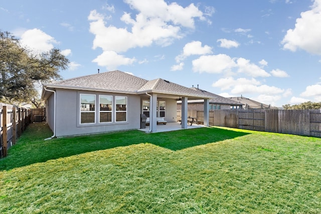 rear view of property featuring a patio area, a fenced backyard, a lawn, and stucco siding