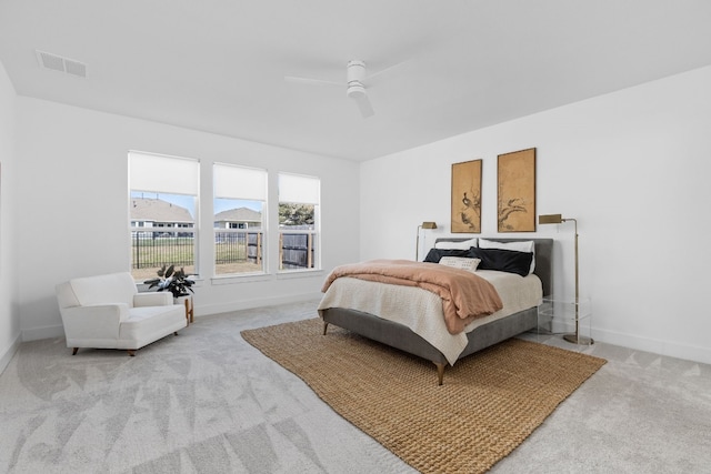 bedroom with carpet flooring, visible vents, baseboards, and a ceiling fan