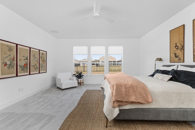 carpeted bedroom featuring visible vents, baseboards, and ceiling fan