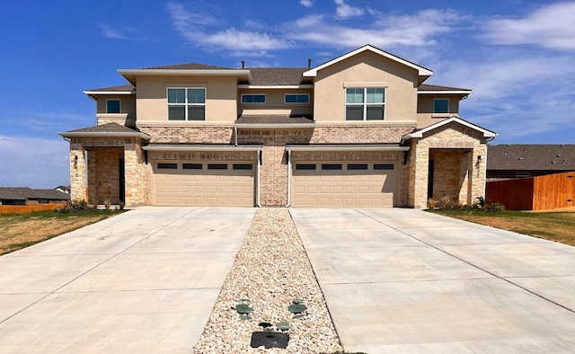 view of front of home featuring a garage, concrete driveway, roof with shingles, and stucco siding