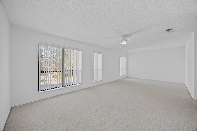 11512 Tin Cup Dr Unit 211, Austin, TX 78750 - unfurnished room featuring a ceiling fan, carpet, and a textured ceiling