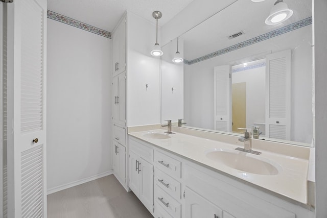 11512 Tin Cup Dr Unit 211, Austin, TX 78750 - bathroom with double vanity and baseboards