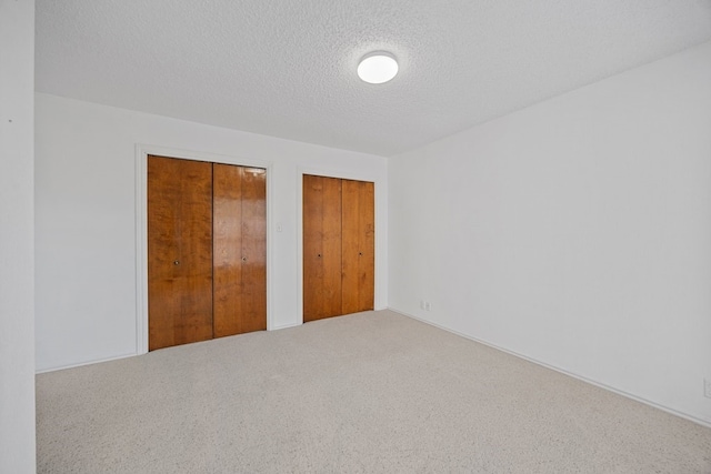 11512 Tin Cup Dr Unit 211, Austin, TX 78750 - unfurnished bedroom featuring carpet and a textured ceiling