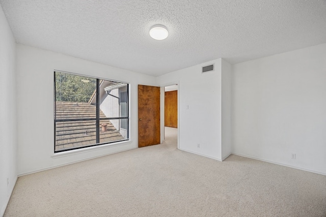 11512 Tin Cup Dr Unit 211, Austin, TX 78750 - carpeted spare room featuring a textured ceiling and baseboards