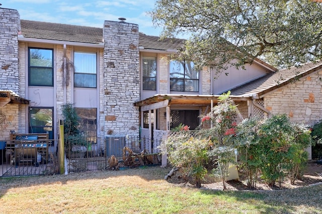 11512 Tin Cup Dr Unit 211, Austin, TX 78750 - back of property with a chimney and stone siding