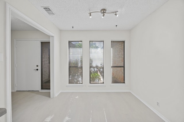 11512 Tin Cup Dr Unit 211, Austin, TX 78750 - spare room featuring wood finished floors and a textured ceiling