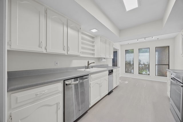 11512 Tin Cup Dr Unit 211, Austin, TX 78750 - kitchen with stainless steel dishwasher, a sink, white cabinets, and a tray ceiling