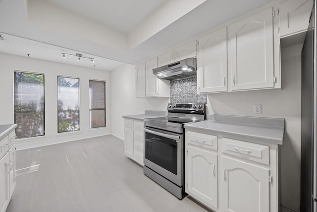 11512 Tin Cup Dr Unit 211, Austin, TX 78750 - kitchen with electric range, under cabinet range hood, white cabinetry, light wood-type flooring, and light countertops