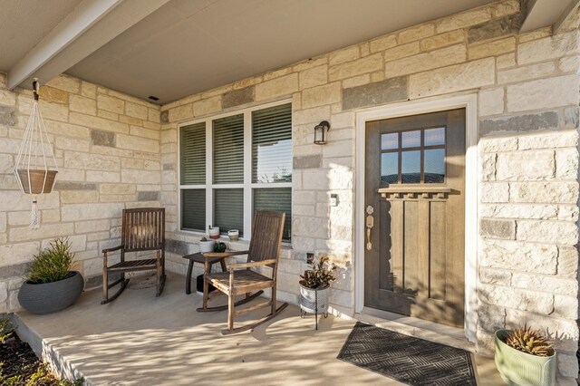 property entrance featuring stone siding