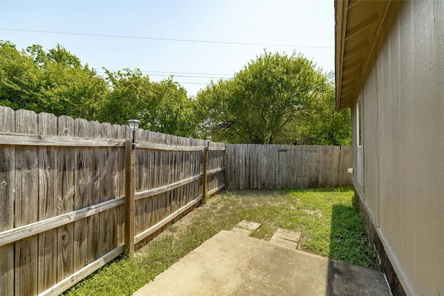 view of yard with a fenced backyard and a patio