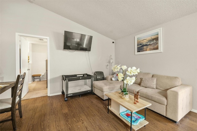 living room with lofted ceiling, dark wood-type flooring, a textured ceiling, and baseboards