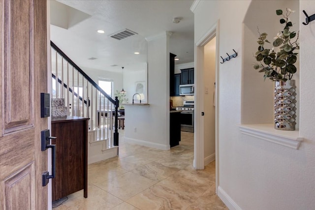 entryway featuring ornamental molding, visible vents, baseboards, and stairs