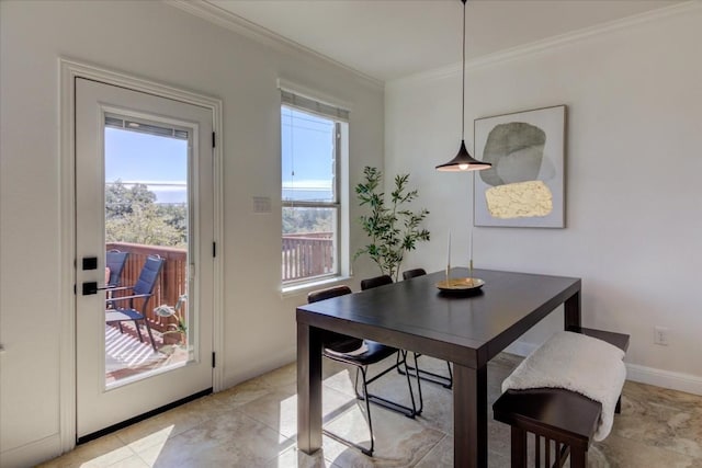 dining space featuring baseboards and crown molding