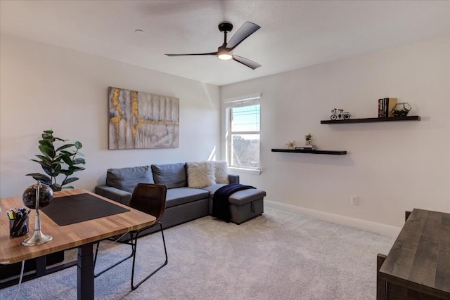 living area featuring ceiling fan, baseboards, and light colored carpet