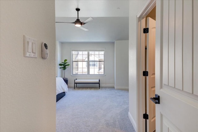 corridor featuring carpet and baseboards