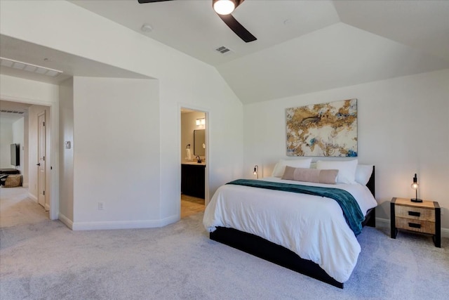 bedroom featuring vaulted ceiling, ensuite bathroom, visible vents, and light colored carpet