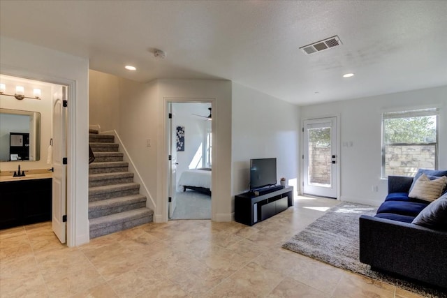 living room with stairway, recessed lighting, visible vents, and baseboards