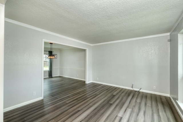 unfurnished room with baseboards, an inviting chandelier, dark wood finished floors, and crown molding