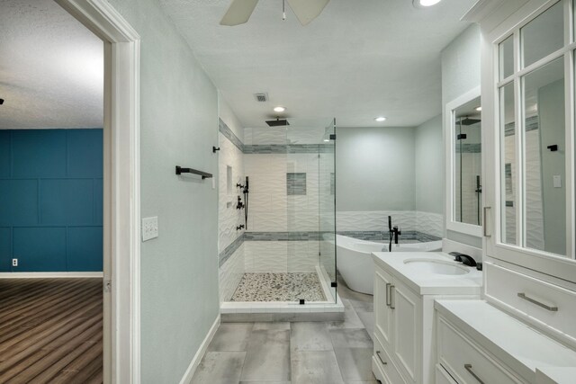 bathroom with visible vents, a freestanding bath, vanity, a shower stall, and recessed lighting