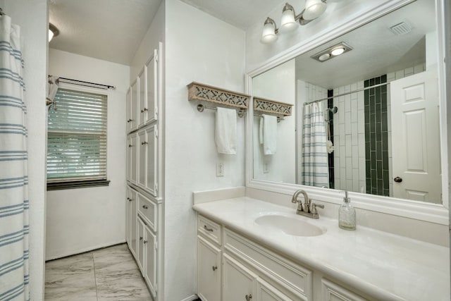 bathroom featuring marble finish floor, visible vents, and vanity