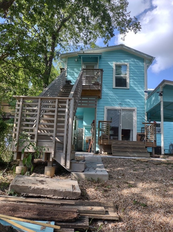 back of house featuring a wooden deck