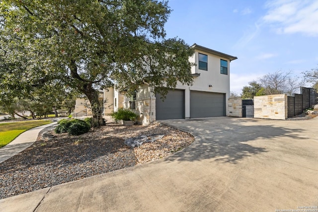 5922 Keller Rdg, New Braunfels, TX 78132 - view of front of home featuring an attached garage, concrete driveway, a gate, and stone siding
