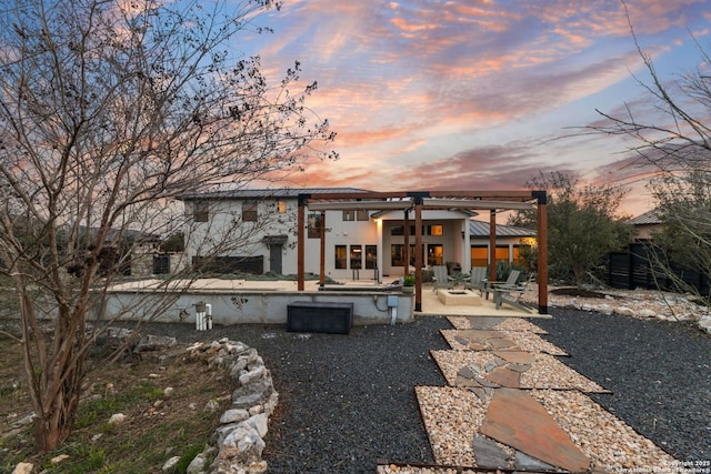 5922 Keller Rdg, New Braunfels, TX 78132 - back of house at dusk featuring a patio area