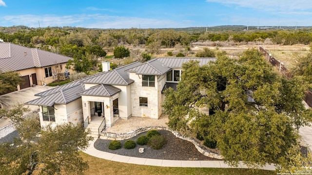 5922 Keller Rdg, New Braunfels, TX 78132 - rear view of house with a standing seam roof, a metal roof, stone siding, and an attached garage