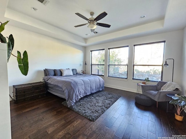 5922 Keller Rdg, New Braunfels, TX 78132 - bedroom featuring a tray ceiling, dark wood-type flooring, and a ceiling fan