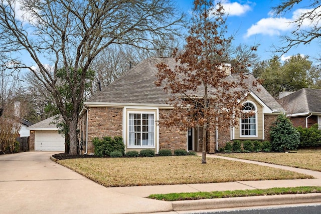 view of front of house with a garage, brick siding, roof with shingles, and a front yard