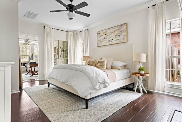 bedroom featuring visible vents, dark wood finished floors, and ornamental molding