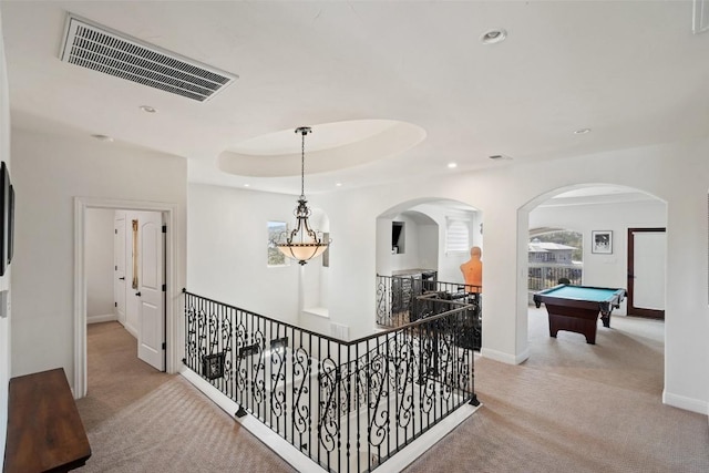 hall featuring recessed lighting, visible vents, light carpet, and a tray ceiling