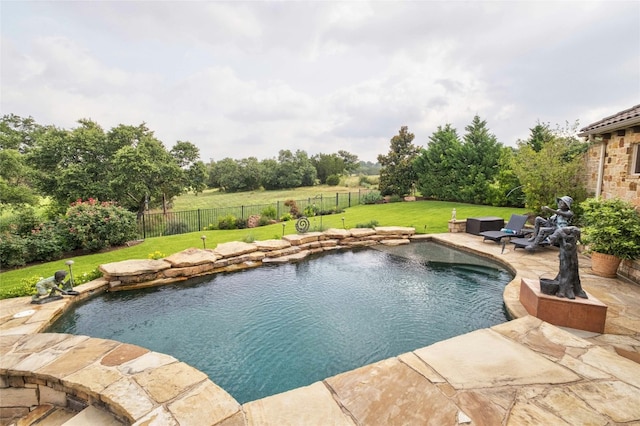 view of swimming pool with a lawn, a fenced in pool, a patio, a fenced backyard, and outdoor lounge area