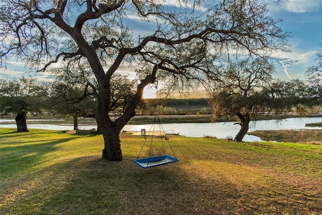 view of community with a water view and a yard