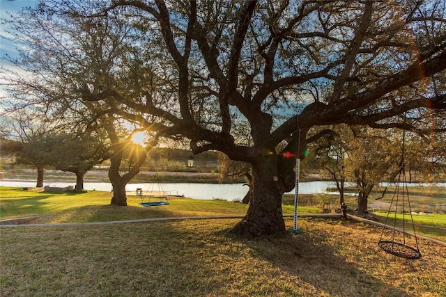 view of property's community with a water view and a yard