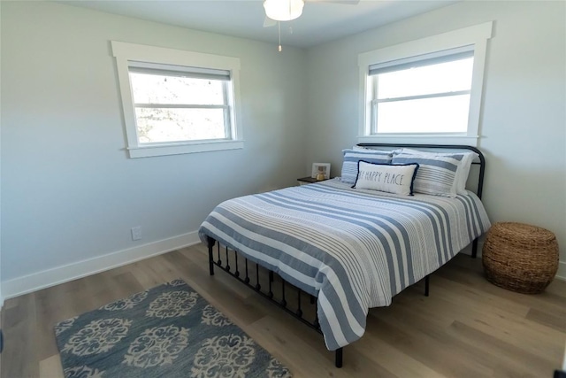 bedroom with wood finished floors and baseboards